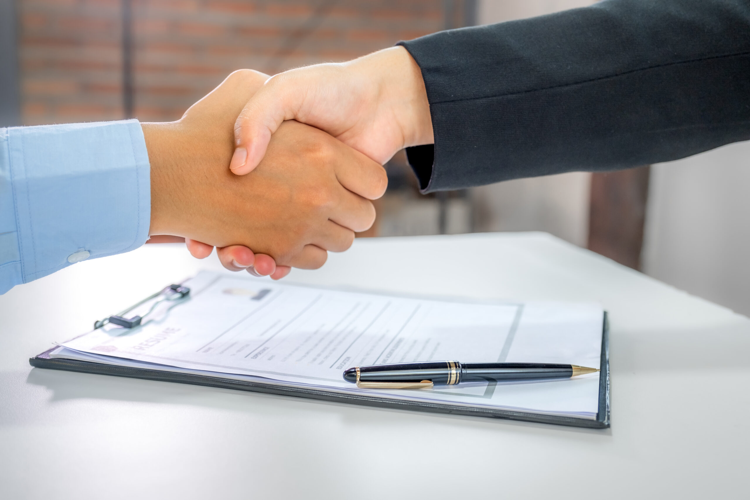 handshake after Office executives interviewing job applicants in the meeting room. employer conversation summary work employment.
